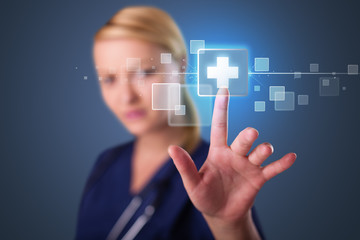 Young nurse pressing modern medical type of buttons