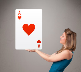 Beautifu woman holding a red heart ace