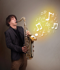 Handsome musician playing on saxophone with musical notes