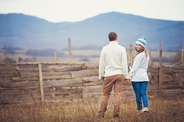 Young couple walking together while enjoying a day in park