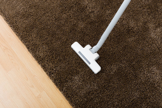 Brown Carpet With Vacuum Cleaner In Living Room