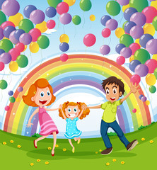 A happy family near the rainbow and balloons