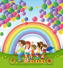 Obraz na płótnie Canvas A multi-wheeled bike below the floating balloons near the rainbo