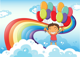 Obraz na płótnie Canvas A boy with balloons standing near the rainbow