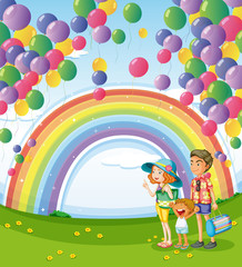 A family strolling with a rainbow and floating balloons