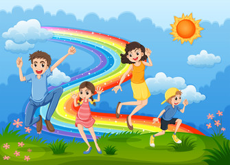 Obraz na płótnie Canvas A family at the hilltop playing with the rainbow