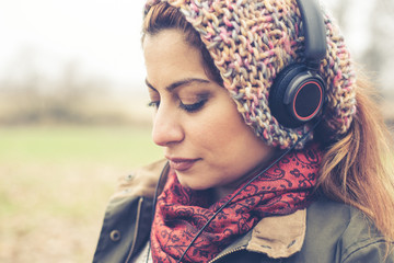 beautiful brunette woman listening to music with headphones