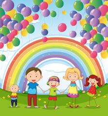 A happy family under the floating balloons with a rainbow