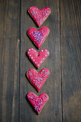 Heart shaped valentine cookies on a wooden board