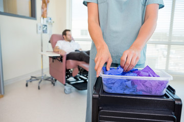 Detail of Nurse Taking Gloves in Chemo Department
