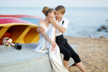 Bride and groom kissing on a beach