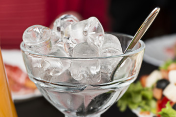 glass vase with ice and spoon