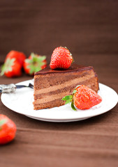 Piece of chocolate cake decorated with fresh strawberry