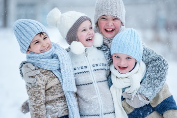 Children playing in the snow on a winter day