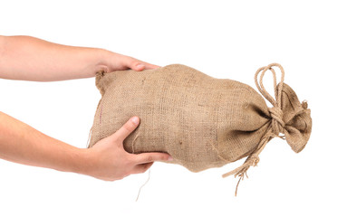 Hands hold full bag with money.