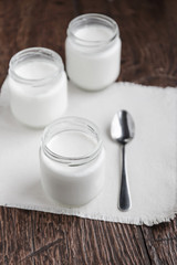 Obraz na płótnie Canvas Three jars of fresh yogurt
