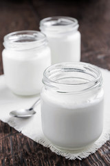 Obraz na płótnie Canvas Three jars of fresh yogurt