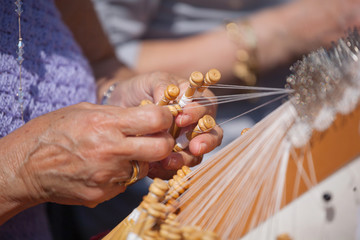 Women`s hands, tatting