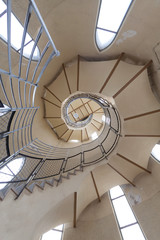 Fototapeta premium Long circular stairs inside the building