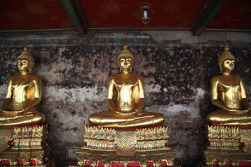 Golden Buddha statues at corridor in Wat Suthat