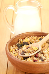 Plate with raw oatmeal on wooden table.