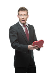 cheerful businessman holding red heart