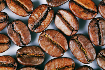 A close-up picture of coffee beans on a white background