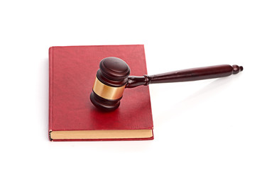 Judge's gavel on red legal book