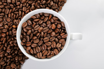 A cup of coffee beans on the edge of diagonal coffee beans shape