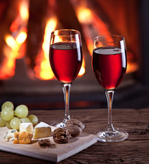 Glasses of wine, cheese and nuts.