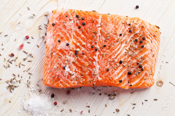 Salmon filet on a wooden carving board.