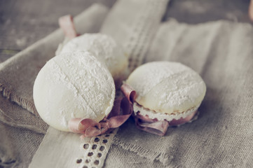 Cupcakes decorated with ribbon and lace on plate