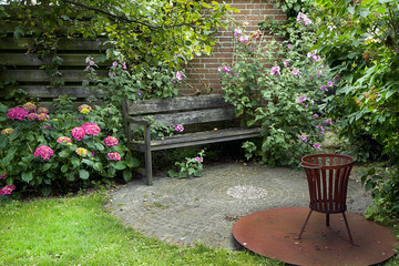 Country-style garden with bench and flowers - 60326817