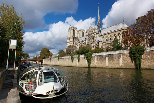 Notre Dame with boat on Seine in Paris, France