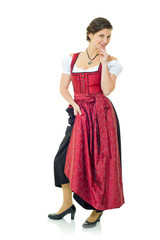 Fototapeta premium Junge Frau im langen Dirndl vor weißem Hintergrund
