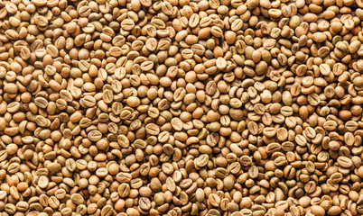 Background texture or fresh raw dried coffee beans