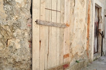 Old abandoned house with wooden doors