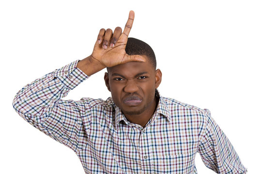 Angry, annoyed young man displaying a looser sign