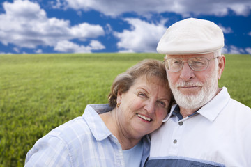 Loving Senior Couple Standing in Grass Field