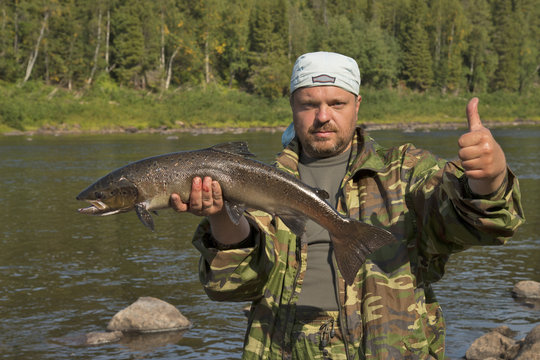 Fisherman Holding A Large Fish.