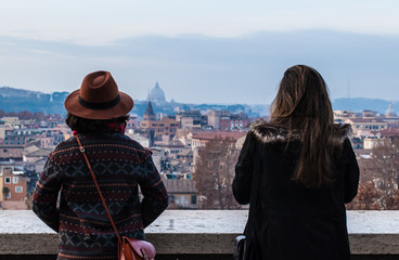 Rear view of two women admiring a view of Rome