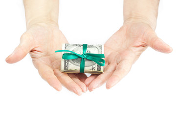 Dollars rolled into a tube tied with ribbon in the hands