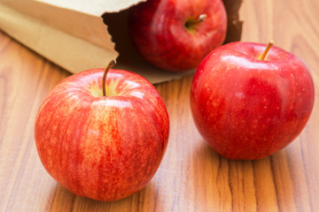 Fresh red apples with paper bag