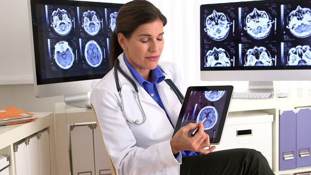 Senior doctor talking to camera about x-ray