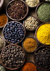 Assortment of spices in wooden bowl background 