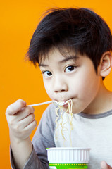 Asian cute boy with noodle cup