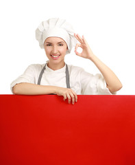 Chef woman holding a blank board and showing ok