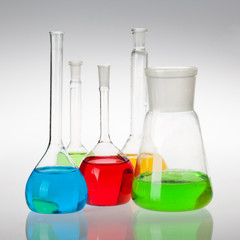 Laboratory glassware with liquids of different colors