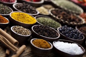Spices on wooden bowl background 