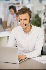 Businessman in the office on the phone, headset, Skype